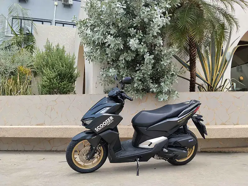 honda click 160cc parked outside a cafe