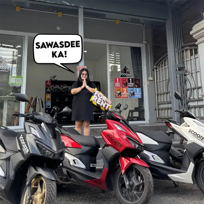 scooter hub owner standing behind some rental scooters